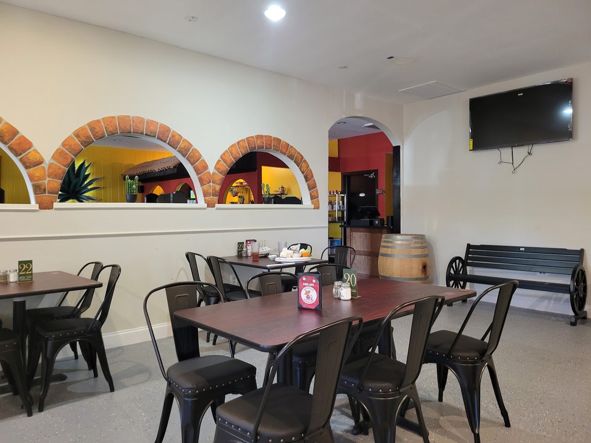 The dining room at Don Lupe: arched windows, metal chairs and wooden tables